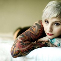 Girl-With-Tattoo-On-Bed-Background-