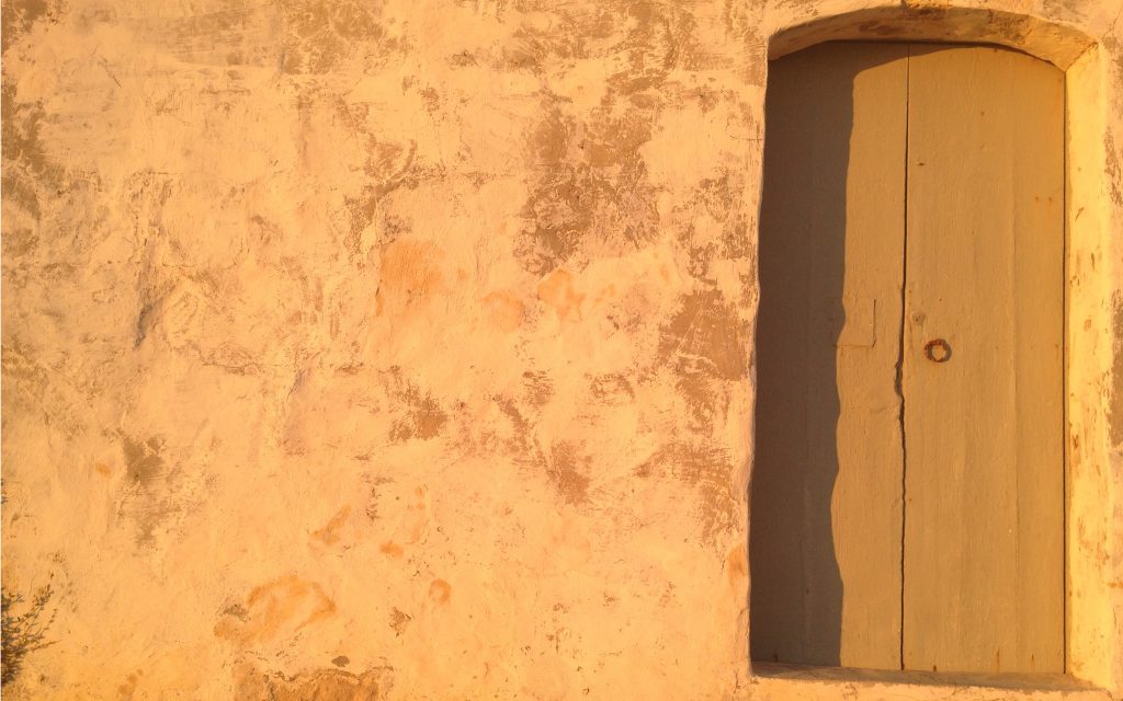 Wall with door on gozo by matthias niess