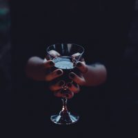 Witch holding a glass of wine by joanna foto
