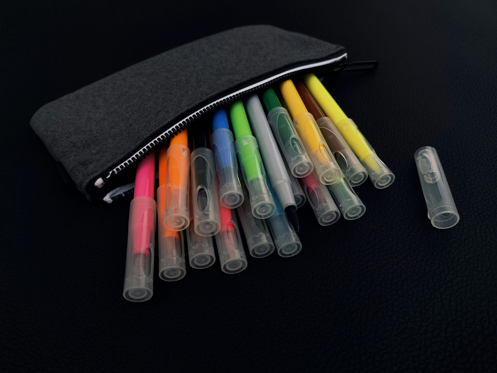 Edubuntu 26.04 anna evans a pouch of markers and pens on a black surface - Edubuntu 26.04 Wallpapers - Official Education-Themed Collection
