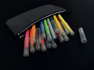 Edubuntu 26.04 anna evans a pouch of markers and pens on a black surface - Edubuntu 26.04 Wallpapers - Official Education-Themed Collection
