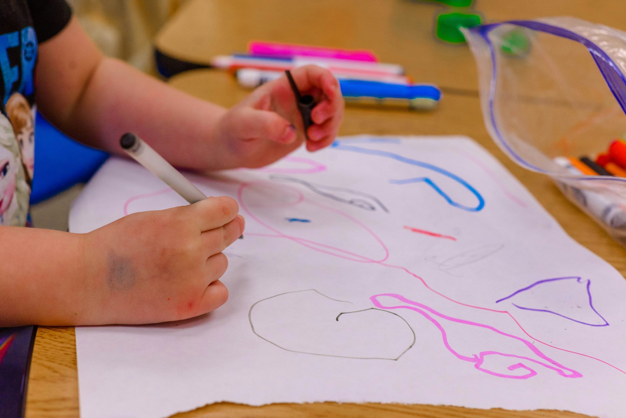 Edubuntu 26.04 erika fletcher a child is drawing on a piece of paper - Edubuntu 26.04 Wallpapers - Official Education-Themed Collection